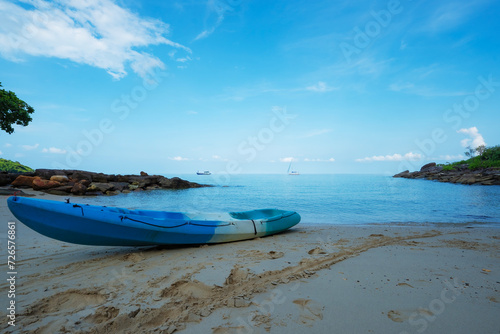 Kayak on the tropical white sand beach with transparent sea on sunny day.