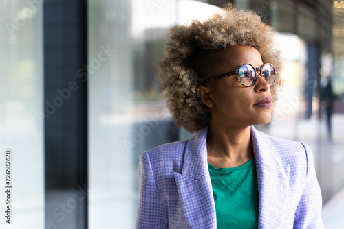 Young professional woman looking inspired at her workplace
