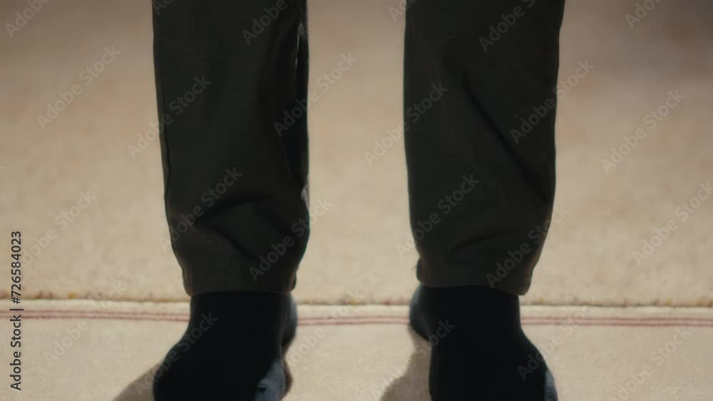 Shot of a Muslim Man Bowing in Prayer With Hands Placed on His Knees Shot of a Muslim Man Bowing in Prayer With Hands Placed on His Knees