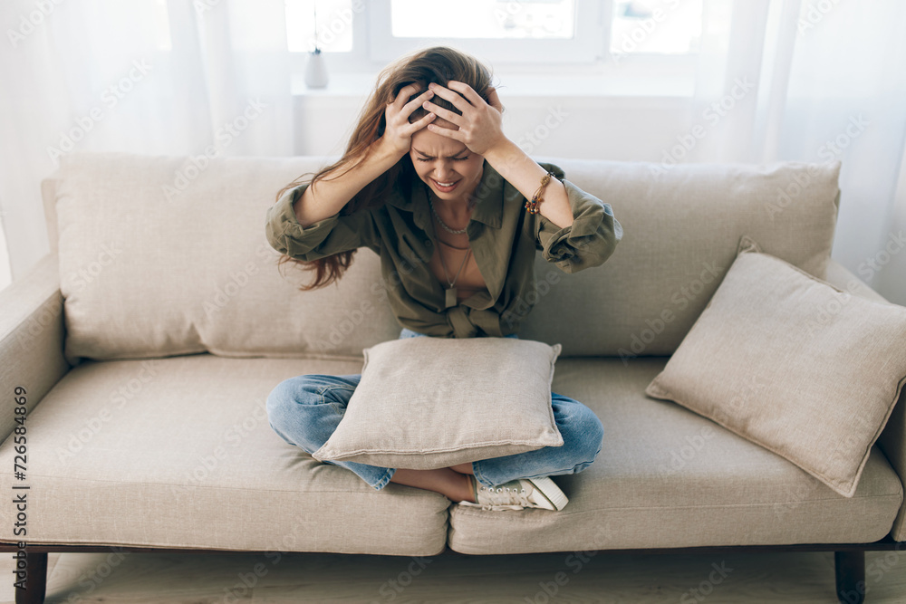 Obraz premium Lonely Woman on Couch, Feeling Sad and Worried in a Home Setting