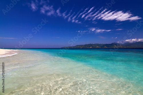 Fototapeta Naklejka Na Ścianę i Meble -  Tropical Asian beach with white sand, turquoise ocean against blue sky with clouds