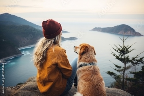 A young women is sitting on the beach with a dog © Rafiqul