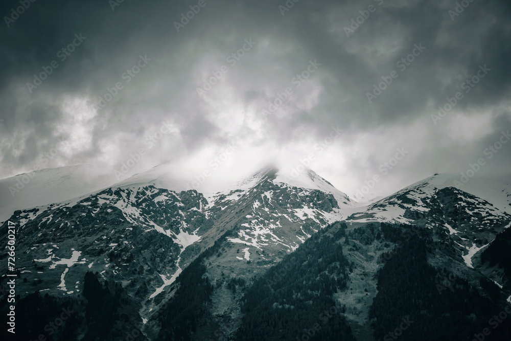 Beautiful mountain landscape. Clouds in the sky. Green grass. Snow on mountain peaks. Beautiful mountain landscape. Clouds in the sky. Green grass. Snow on mountain peaks.