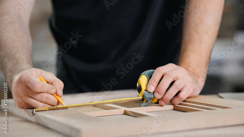 Banner DIY carpentry workshop industry. Closeup of craftsman hand making wooden facade of handmade kitchen furniture