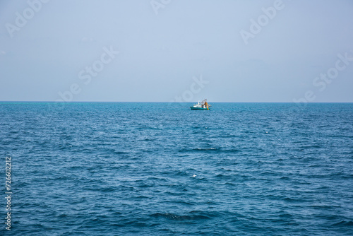 distant fishing trawler on the pacific ocean photo