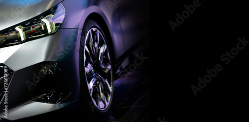 Front view of LED headlights sedan car on black background, free space on right side for text