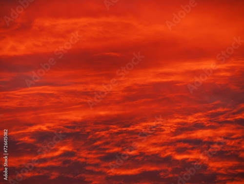 Sunset in the mountains with orange red sky and clouds. Winter Carpathian Mountains view cloudscape. Pine fir tree forest in Carpathians Scenic wood landscape Village in Transcarpathia Ukraine, Europe © KawaiiS