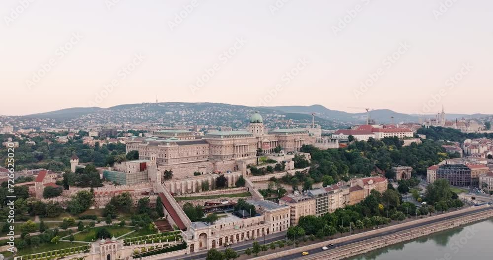 Royal Palace in Buda Castle aerial view from drone on street quarters of Budapest, Hungary in cloudy weather in summer. Historical center of Buda and Pest. Travel destination drone. Tourism Royal Palace in Buda Castle aerial view from drone on street quarters of Budapest, Hungary in cloudy weather in summer. Historical center of Buda and Pest. Travel destination drone. Tourism