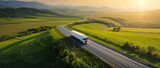 Truck on an open road through vibrant green fields, symbolizing logistics and freedom of travel