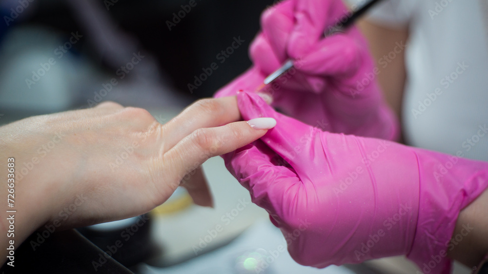 a girl gets a manicure in a beauty salon a girl gets a manicure in a beauty salon