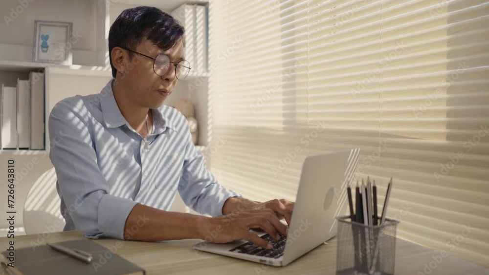 Man using laptop to work on table in office, Press the keyboard on the laptop, Remote work. Man using laptop to work on table in office, Press the keyboard on the laptop, Remote work.