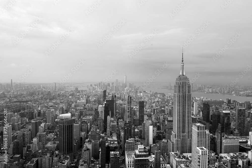 Black and white view of New York City skyline looking down past the Empire State Building towards downtown skyscrapers with vintage colors giving off a 90's feel