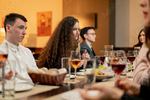 work colleagues are sitting in a restaurant celebrating the conclusion of a new deal a successful business proposal