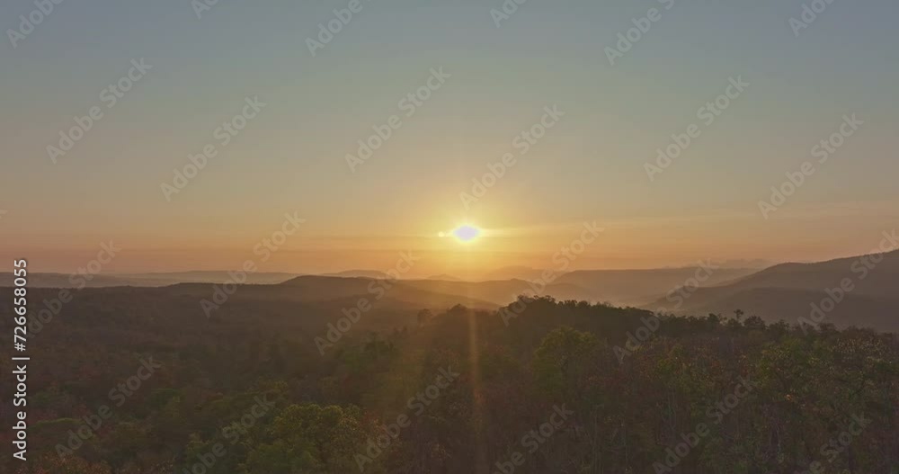 Panoramic aerial view of beautiful sunrise over a large forest..Autumn landscape across the mountains. Vibrant foliage and .beautiful scenery The leaves are changing color all over the forest. Panoramic aerial view of beautiful sunrise over a large forest..Autumn landscape across the mountains. Vibrant foliage and .beautiful scenery The leaves are changing color all over the forest.