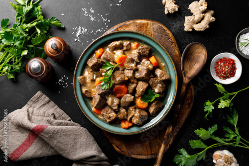 Beef meat goulash with carrot and onion, beef and carrot stew, top view