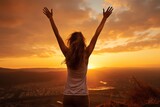 woman celebrate running with arms raised outdoors at sunset
