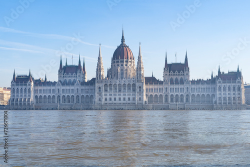 The neo-Gothic building of the Hungarian legislature, the Parliament with the river Danube flooding the quays in the foreground