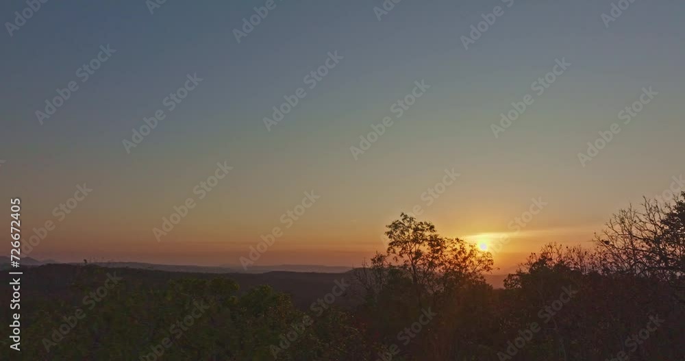 aerial view A beautiful sunrise paints the sky in vivid shades of orange and red over a deciduous forest..Colorful leaves when the season comes to bloom in the big forest..beautiful nature background aerial view A beautiful sunrise paints the sky in vivid shades of orange and red over a deciduous forest..Colorful leaves when the season comes to bloom in the big forest..beautiful nature background