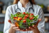 A female doctor nutritionist holding a bowl with a healthy vegetable salad