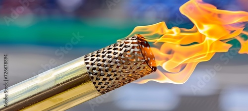 Blazing olympic torch illuminates sports arena with copy space for text placement