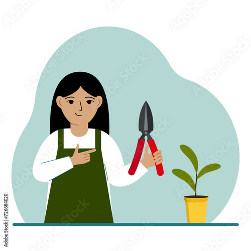 A gardener is a girl in working clothes, he has a pruner in his hand.