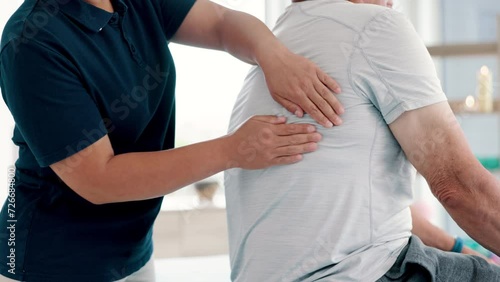 Physical therapy, back massage and chiropractor with elderly man in medical office at clinic. Rehabilitation, patient and closeup of physiotherapist helping senior male person healing muscle pain. photo