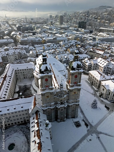 Dronephoto from the monastery in saint gallen  st. gallen  at winter with snow on the roof.
