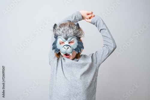 The sleepy wolf stretching, isolated on a gray background. Early child development and imagination. Play accessories, photo booth props for kids