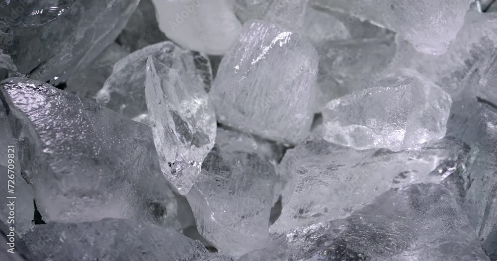Pieces of ice in the container. Chilled water. Shine from natural crystals. Pieces of ice in the container. Chilled water. Shine from natural crystals.