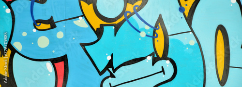 Colorful background of graffiti painting artwork with bright aerosol outlines on wall. Old school street art piece made with aerosol spray paint cans. Contemporary youth culture backdrop