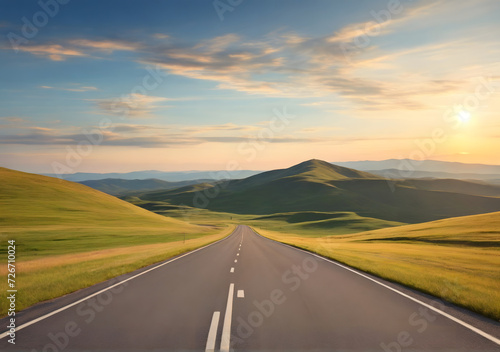 Empty long mountain road to the horizon on a sunny summer day at bright sunset