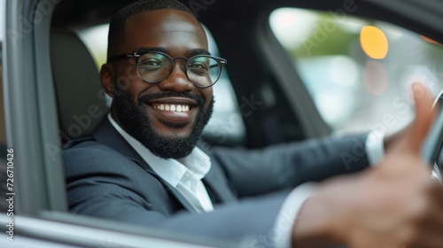 Cheerful African American businessman driving in his car © artem