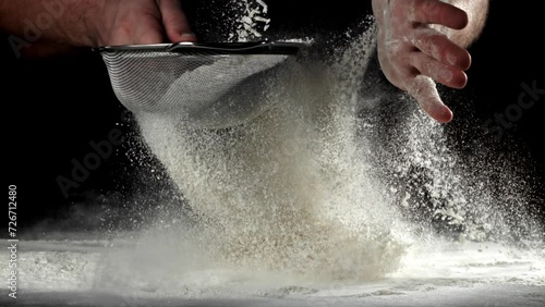 The cook sifts the flour. Filmed on a high-speed camera at 1000 fps. High quality FullHD footage photo