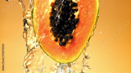 Fresh tropical papaya with drops and splashes of water. Filmed on a high-speed camera at 1000 fps. High quality FullHD footage