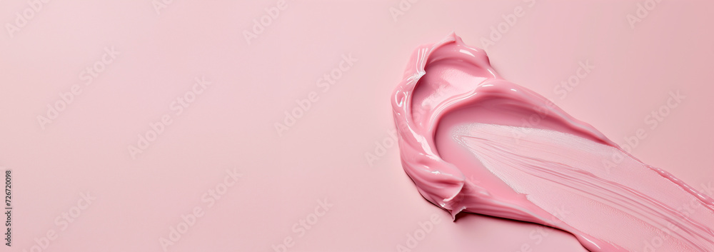 Smear of pink creamy cosmetic product on a pink background. Beauty and skincare concept with a close-up view and space for text. Smear of pink creamy cosmetic product on a pink background. Beauty and skincare concept with a close-up view and space for text.
