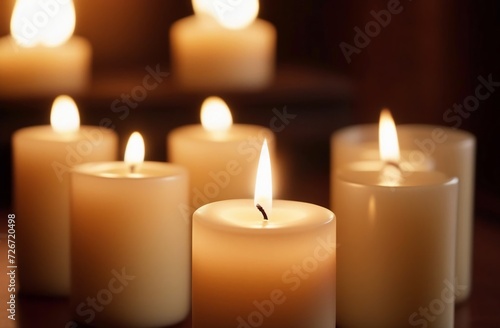 Several lighten candles on wooden surface on dark background
