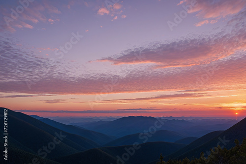Beautiful sunset sky in the clouds on top of grassy mountains
