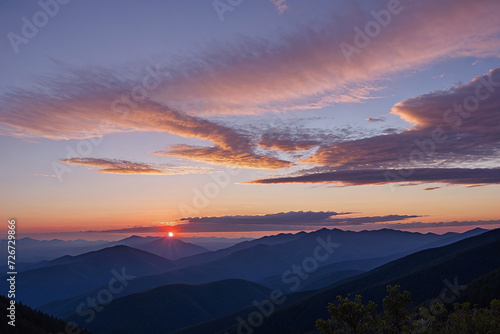 Beautiful sunset sky in the clouds on top of forested mountains