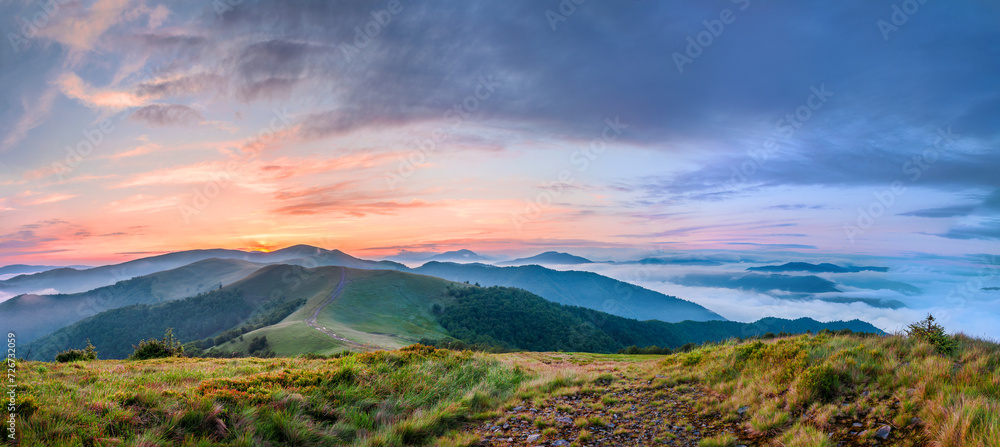 Amazing sunset in the Carpathian mountains. A panoramic view of the mountains and the sea of fog. Carpathians, Ukraine