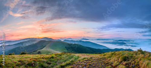 Amazing sunset in the Carpathian mountains. A panoramic view of the mountains and the sea of fog. Carpathians, Ukraine photo