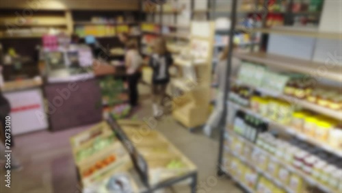 customers and cashier in local grocery shop photo