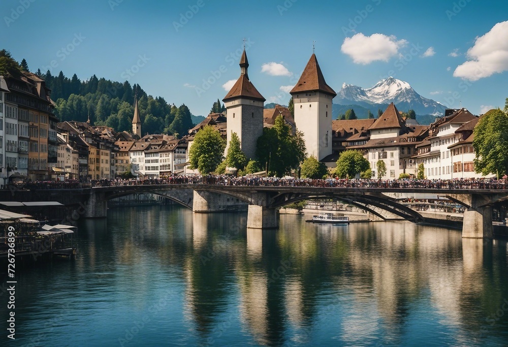 Fototapeta premium Scenic panoramic view of a city with river, bridge, chapel and mountains