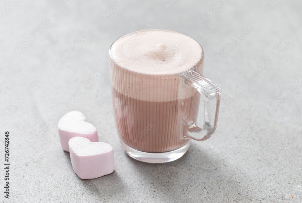 Chocolate cappuccino with marshmallows in the shape of a heart. In a glass cup. Light grey background. Valentine's Day. Close up Chocolate cappuccino with marshmallows in the shape of a heart. In a glass cup. Light grey background. Valentine's Day. Close up