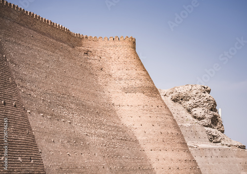 Ark Citadel with brick fortress walls in the ancient city of Bukhara in Uzbekistan on a warm summer sunny day, a stone fort photo