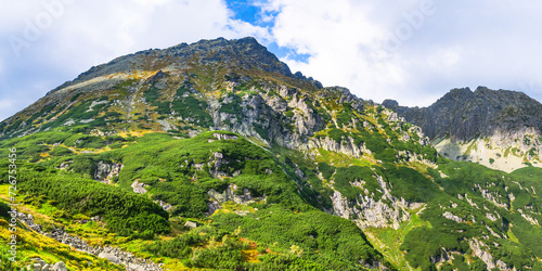 Fototapeta Naklejka Na Ścianę i Meble -  Polish Tatra Mountains, high mountain hiking trail leading to mountain peaks, mountain landscape with valleys and slopes, view on a sunny summer day.