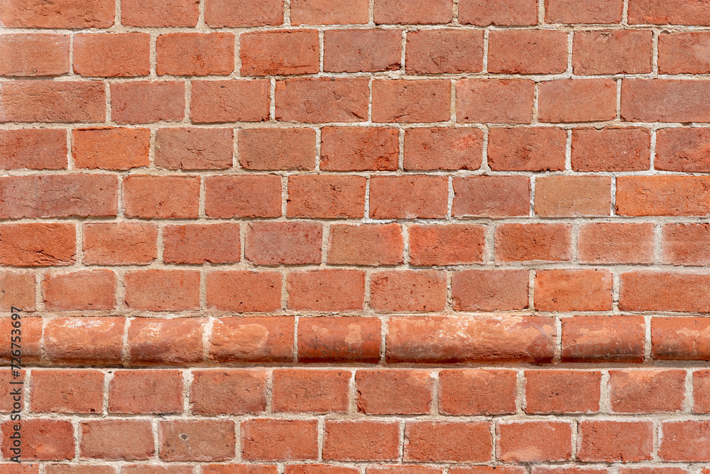 Obraz premium Wall texture with red bricks, geometric background with horizontal row of protruding, round red bricks, Background with copy space