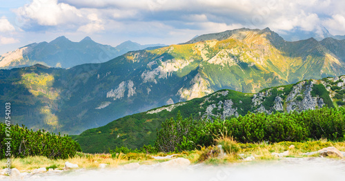 Fototapeta Naklejka Na Ścianę i Meble -  Polish Tatra Mountains, high mountain hiking trail leading to mountain peaks, mountain landscape with valleys and slopes, view on a sunny summer day.
