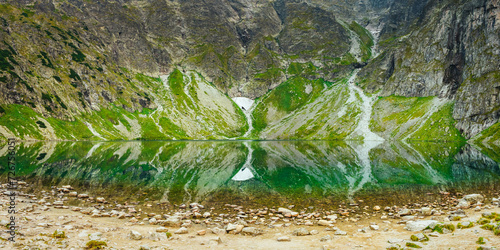 Polish Tatra Mountains, Czarny Staw, view from the trail and the shore of a pond with clear water at the foot of the mountain