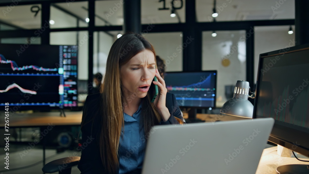 Stressed broker talking mobile phone in office. Upset woman get bad news on call Stressed broker talking mobile phone in office. Upset woman get bad news on call