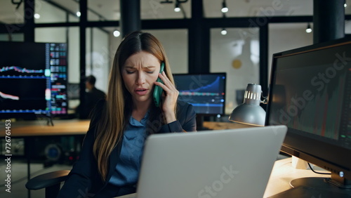 Stock trader working office ending phone call. Pensive woman analyse statistics